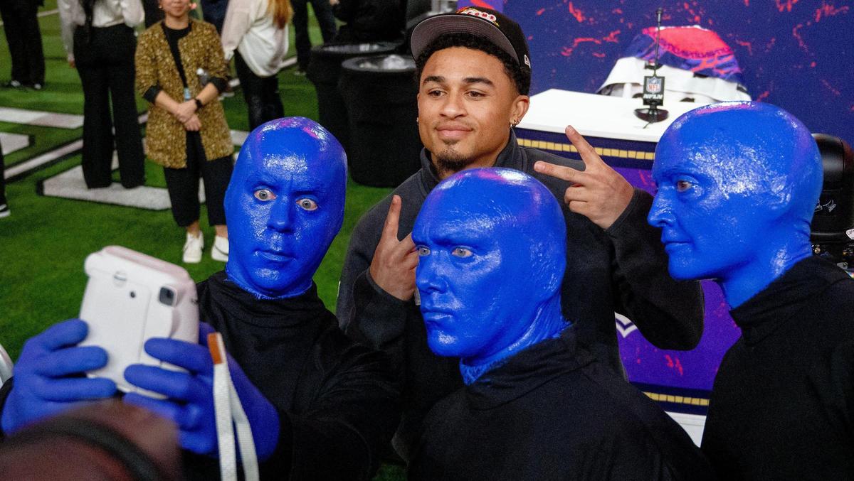 Kansas City Chiefs cornerback Trent McDuffie takes a selfie with members of Blue Man Group during Super Bowl LVIII’s Opening Night event at Allegiant Stadium on Monday, Feb. 5, 2024, in Las Vegas.