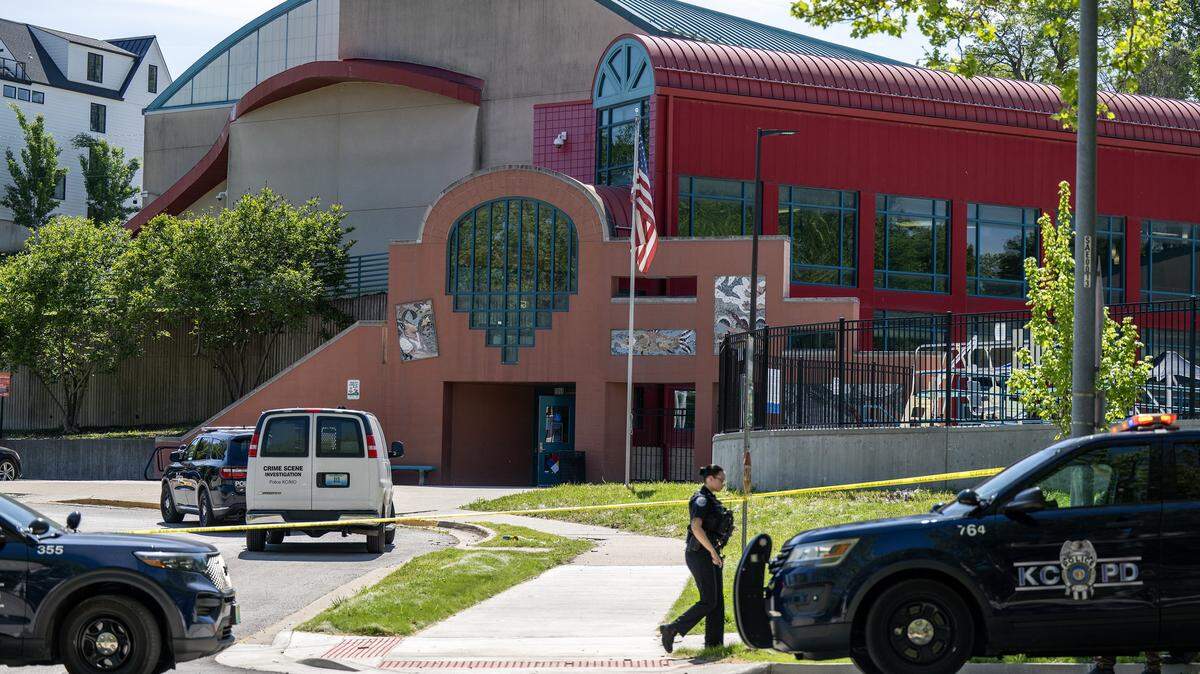Police vehicles are parked outside the Tony Aguirre Community Center following a shooting on Sunday, May 3, 2026, in Kansas City.