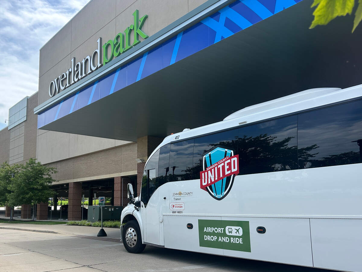 A shuttle from the new Johnson County United Airport Drop and Ride service waits for passengers outside the Overland Park Convention Center drop-off point on June 8, 2026.