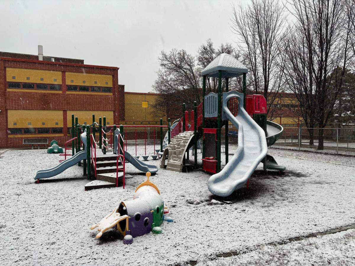 Snow coated the playground equipment at Longfellow Elementary School in Kansas City at 4:15 p.m. on Monday. North-south streets in the surrounding neighborhood were mostly wet, while cross streets were covered in slush.