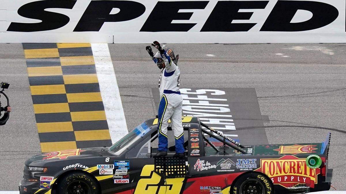 Brett Moffitt (23) celebrates after winning the NASCAR Truck Series auto race at Kansas Speedway in Kansas City, Kan., on Saturday.