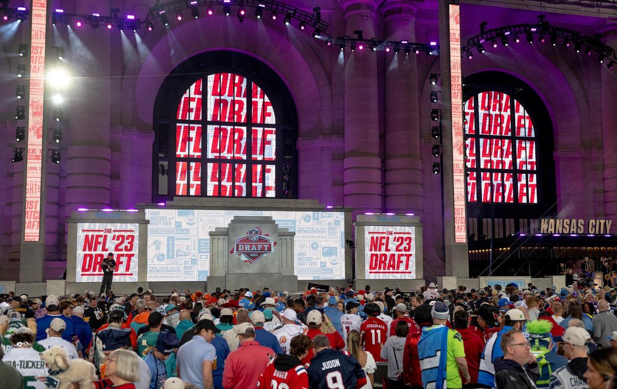 Football fans wait for the start of the NFL Draft outside of Union Station on Thursday, April 27, 2023, in Kansas City.