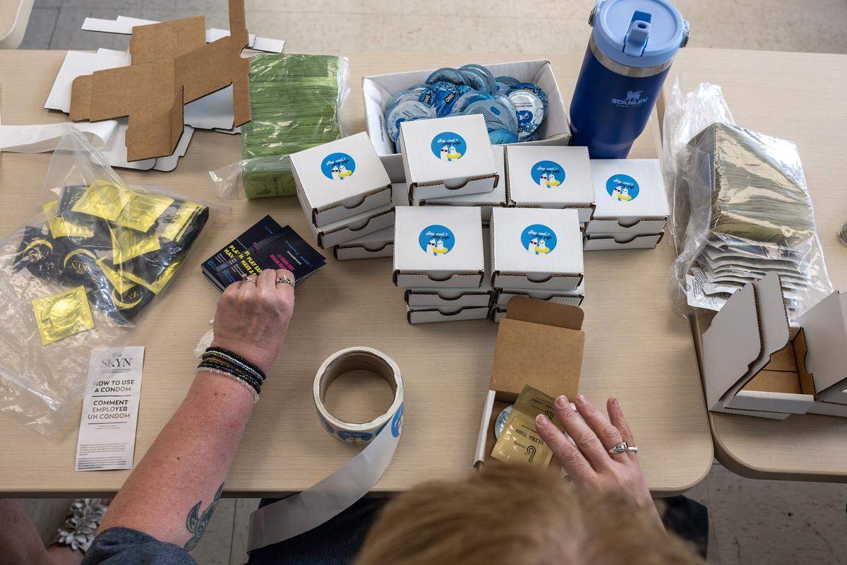 A volunteer assembles safer-sex kits containing condoms and other sexual health supplies at Our Spot KC on Thursday, June 4, 2026, in Kansas City. Planned Parenthood aims to distribute 5,000 free kits during FIFA World Cup matches in the Kansas City area.
