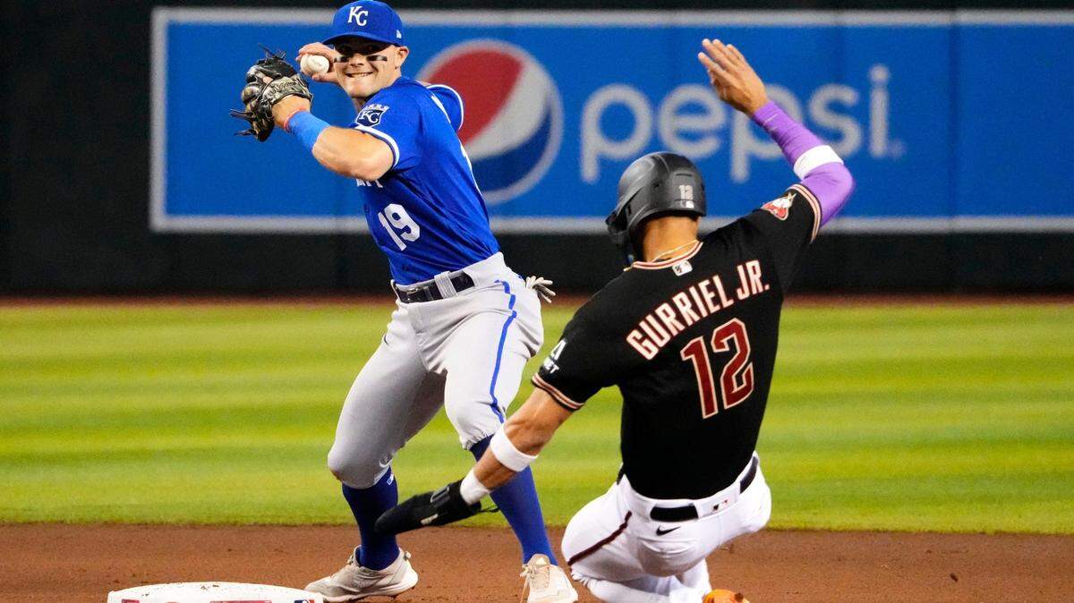 Royals second baseman Michael Massey turns a double play over a sliding Arizona’s Lourdes Gurriel Jr. during Wednesday’s game at Chase Field.