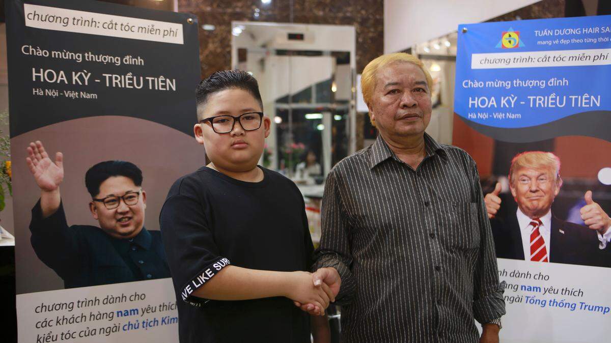 Le Phuc Hai, 66 and To Gia Huy, 9, pose for a photo after having Trump and Kim haircuts in Hanoi, Vietnam, on Tuesday, Feb.19, 2019. U.S. President Donald Trump and North Korean leader Kim Jong Un have become the latest style icons in Hanoi, a week before their second summit is to be held in the capital city of Vietnam.