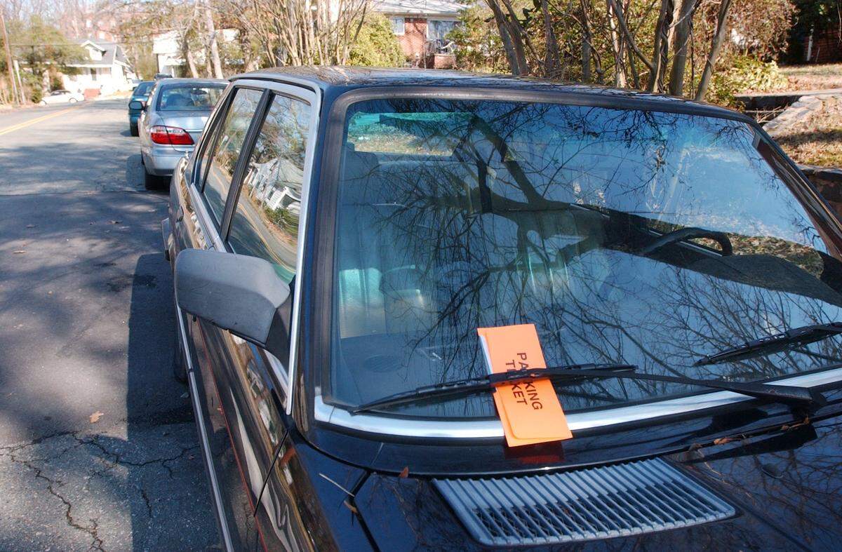 A parking ticket graces a vehicle at a residential side street in North Carolina.