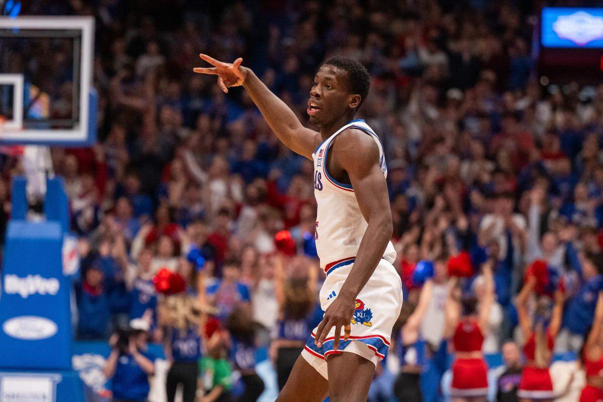 Kansas Jayhawks guard Melvin Council Jr. (14) flashes three fingers after making a 3-point jumper in the first half vs. the Towson Tigers on Tuesday, December 16, 2025, at Allen Fieldhouse.