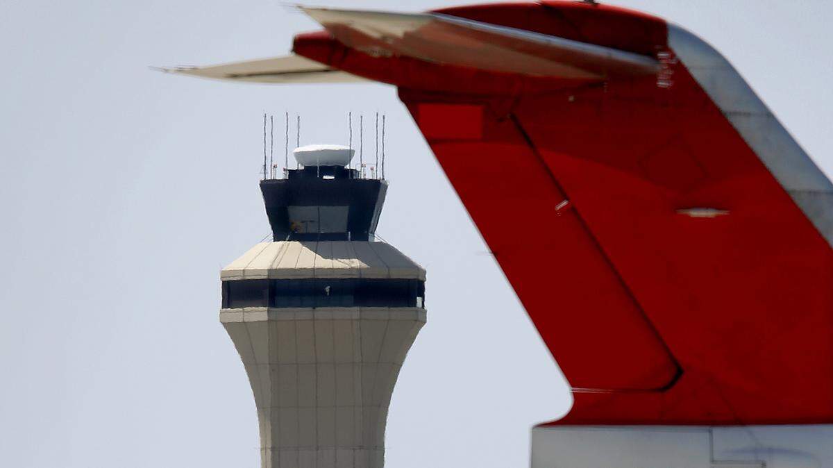 The Kansas City International Airport control tower rises up behind aircraft sitting at the old TWA overhaul base.