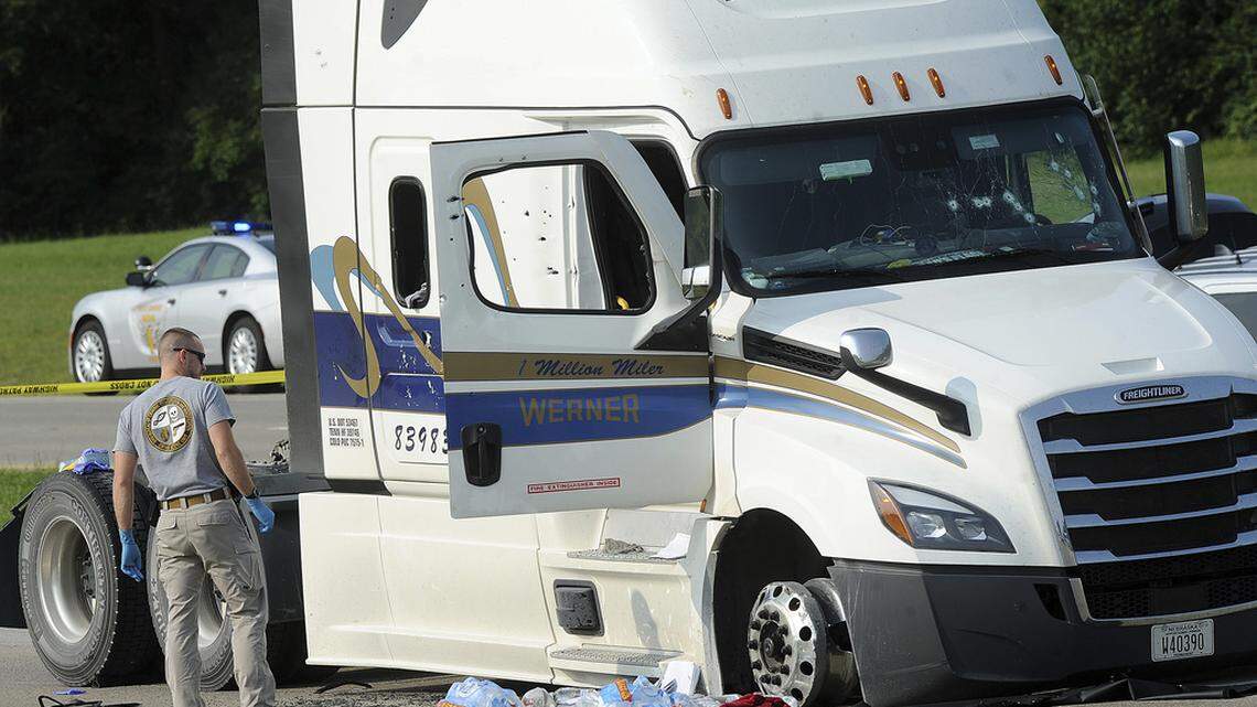 A member of the Ohio Bureau of Criminal Investigation looks over a semi-truck that was highjacked from London, Ohio, and stopped near the Dayton International Airport in Dayton, Ohio, early Wednesday, Aug. 2, 2023. The police pursuit in Ohio eventually led to the kidnapping of a tractor-trailer driver, spurring a lengthy standoff near the airport that culminated in a shootout between two suspects and Ohio state troopers, leaving both suspects mortally wounded.