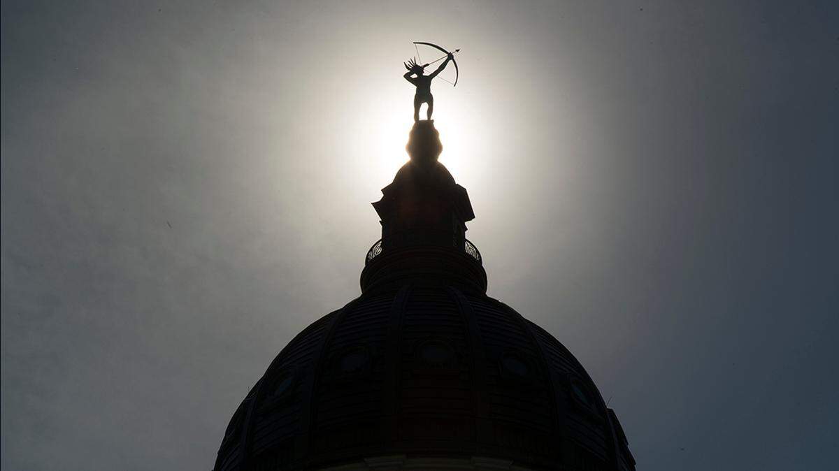 Ad Astra, the bronze statue of a Kansa warrior, is silhouetted atop the dome of the Kansas Statehouse.

20160609 Capitol Outside Dome 