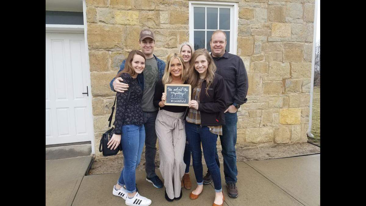 A group at an escape room at Lanesfield School celebrates solving a mystery.