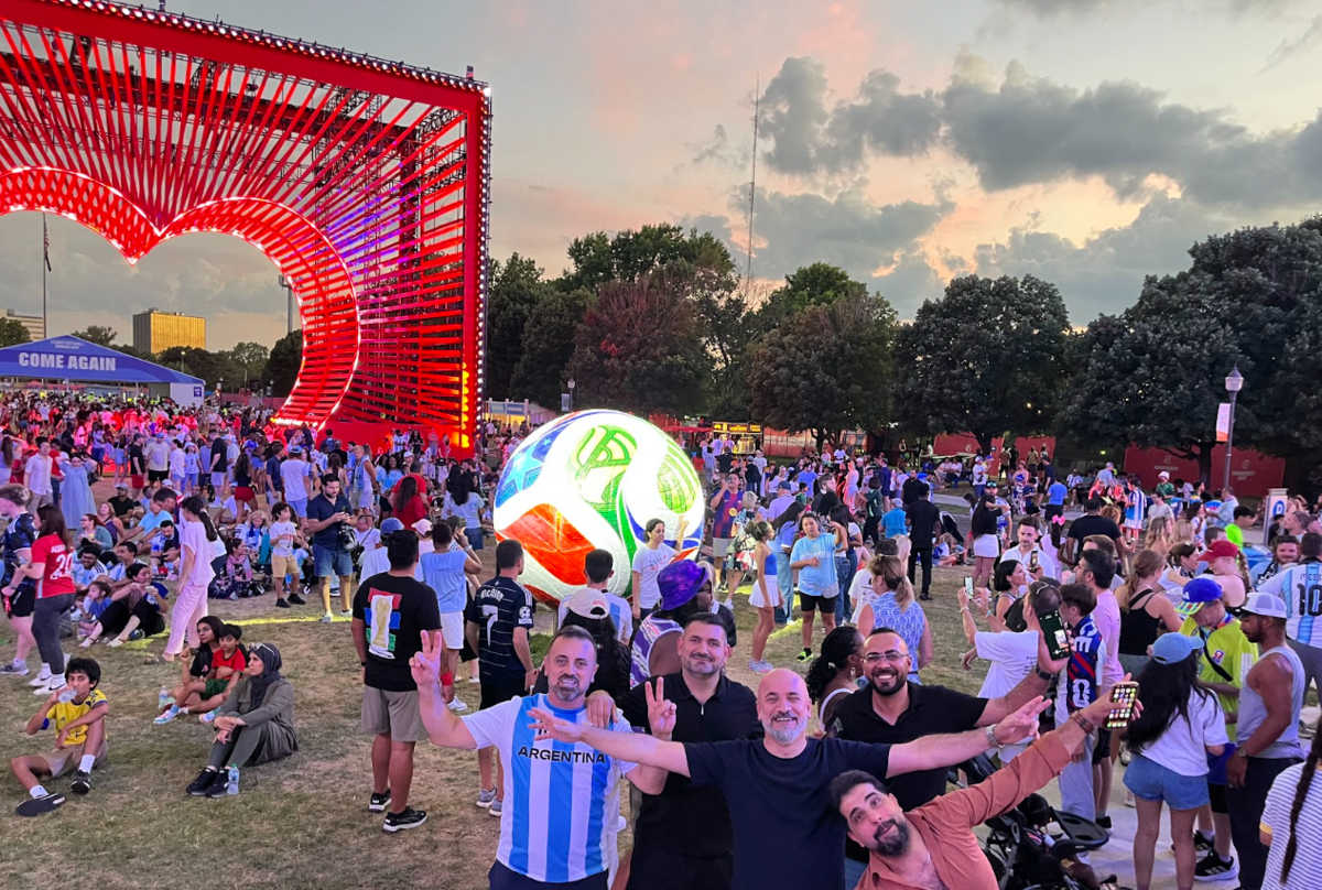 Argentina fans pose in front of the heart structure at FIFA Fan Fest on the last day the experience will be open, July 11.