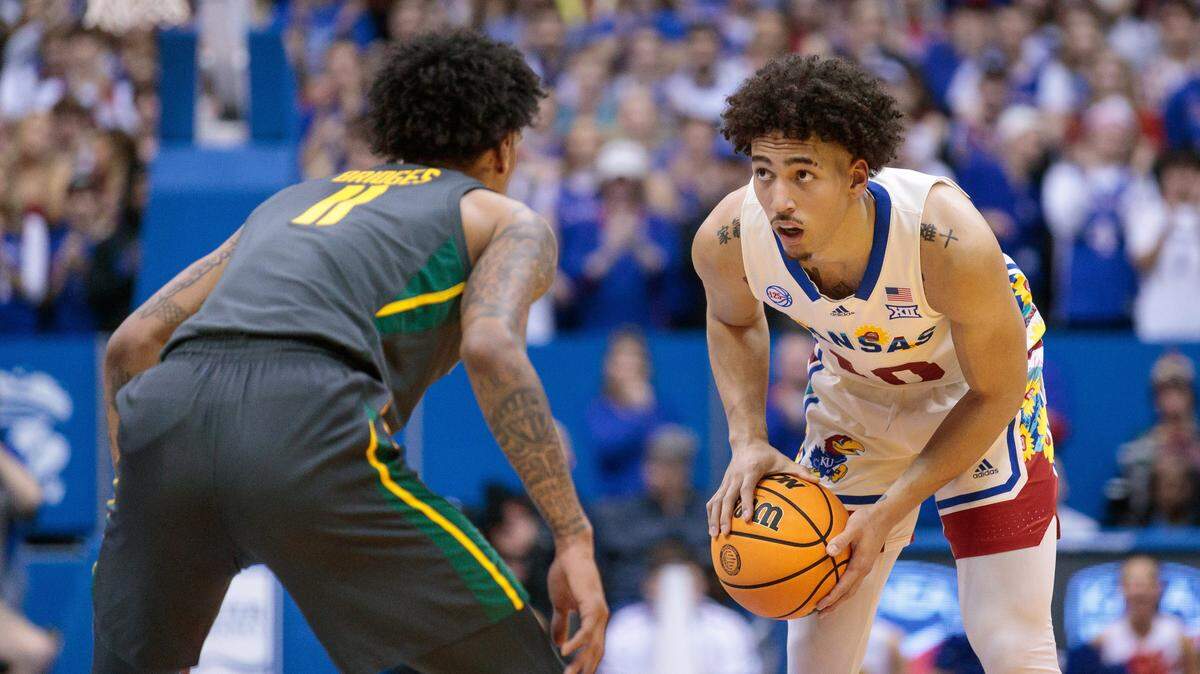 Kansas Jayhawks forward Jalen Wilson (10) controls the ball against Baylor Bears forward Jalen Bridges (11) during the second half at Allen Fieldhouse on Feb. 18, 2023.