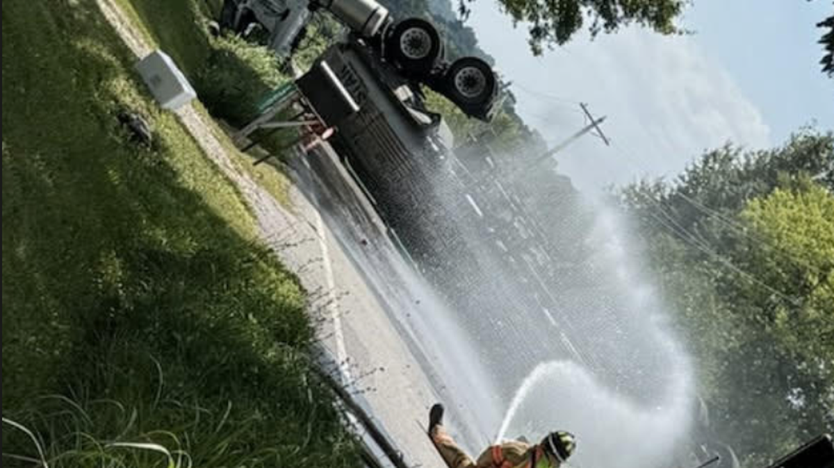 Firefighters in Kearney, Missouri in cleanup efforts following the overturning of a semi carrying gasoline.