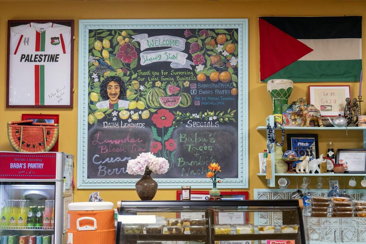 Kamal Kamal, an interior designer and one of Yahia Kamal's two sons, decorated Baba's Pantry with items honoring the family's Palestinian roots. Kamal's image appears on a chalkboard at Baba's Pantry, 1019 E. 63rd St., photographed Tuesday, May 19, 2026, in Kansas City.