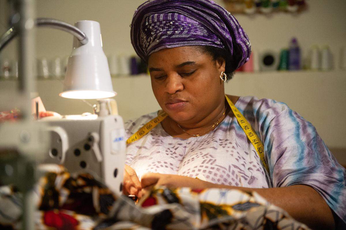 Liliane Lemani, a refugee from Democratic Republic of Congo, honed her Sewing Skills at Kansas City’s Rightfully Sewn, opened her own dress shop and now is making masks to fight the spread of COVID-19 in the U.S.
