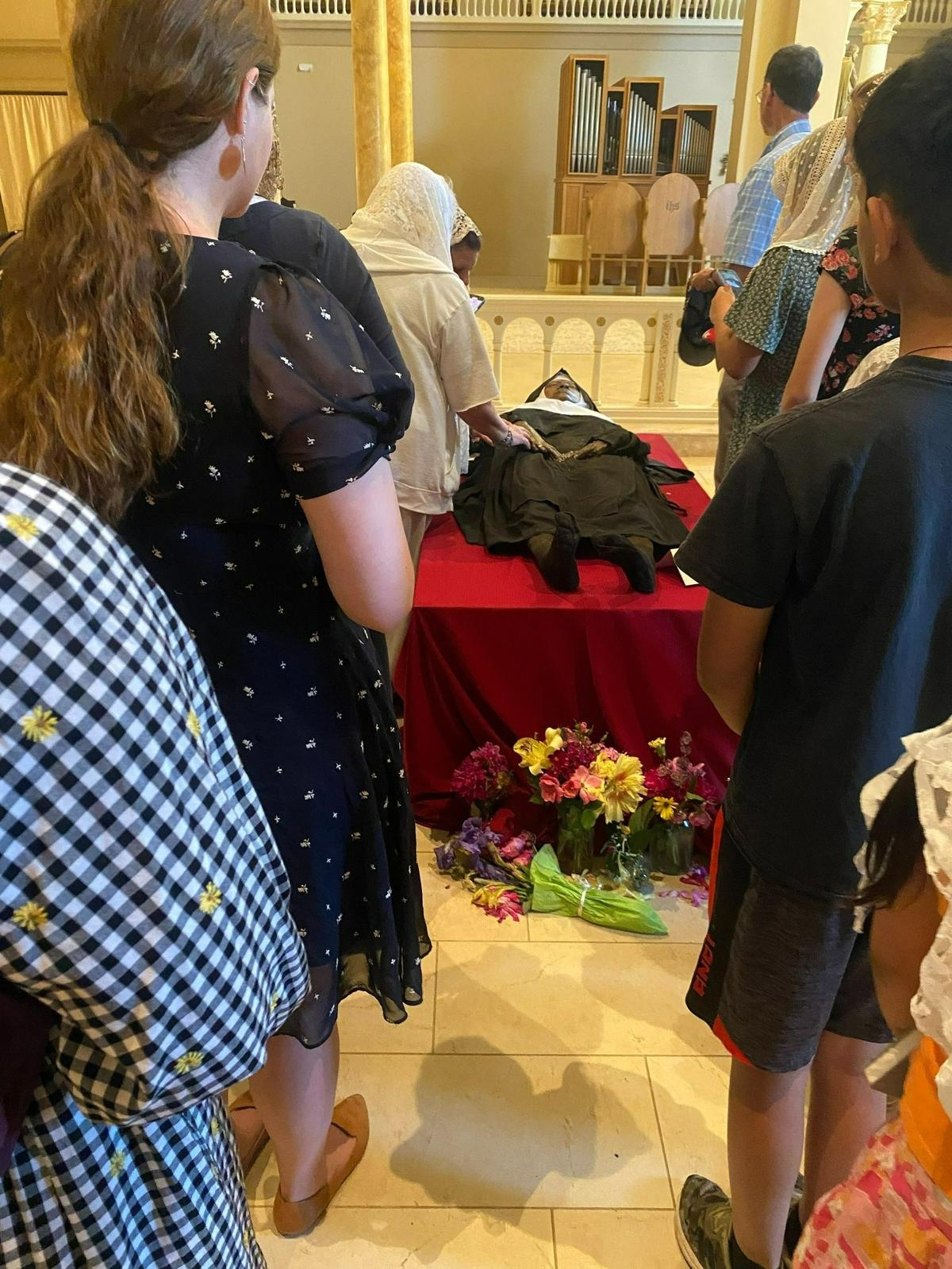 Catholics line up to pray beside the body of Sister Wilhelmina Lancaster in 2023.