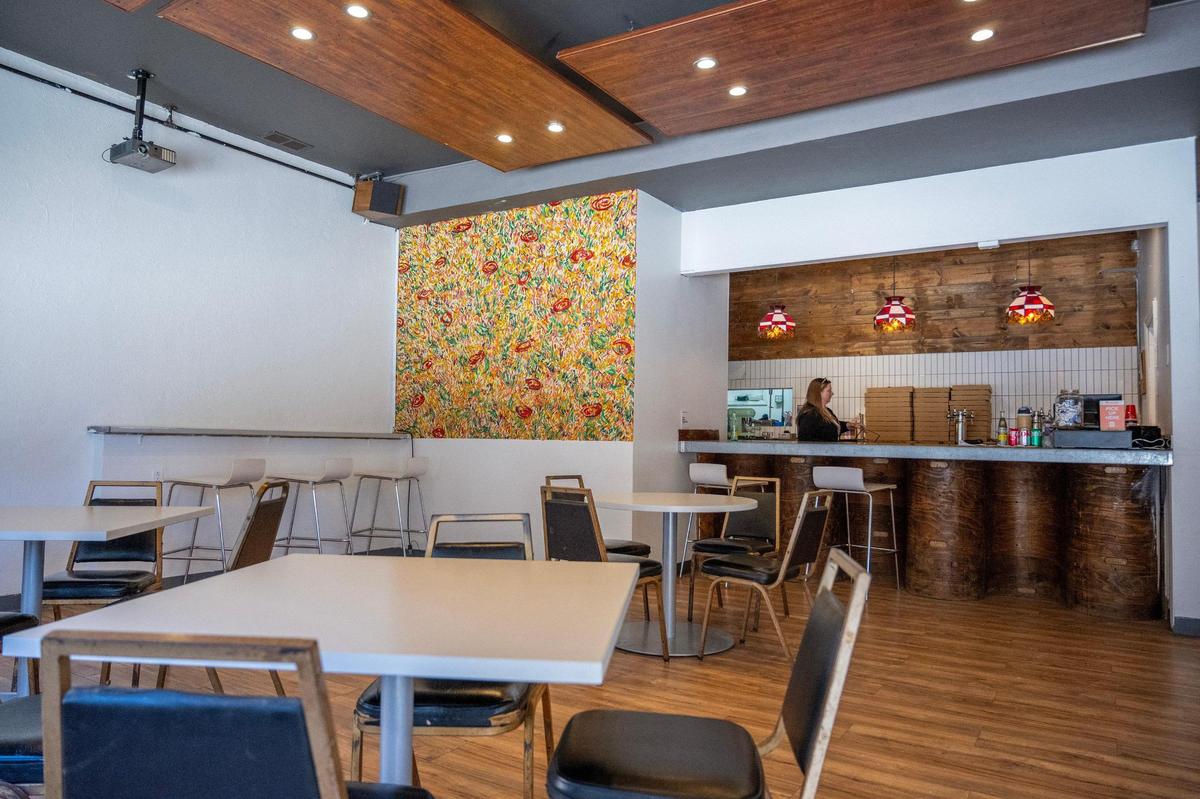 The interior of Fortunati Pizza is pretty nondescript, except for this mural by artist Jake Schildtknecht.