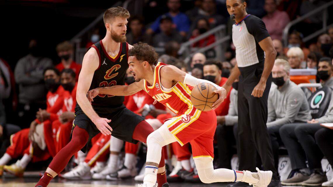 Atlanta Hawks guard Trae Young (11) makes a move against Cleveland Cavaliers forward Dean Wade (32) during the first quarter at State Farm Arena on Feb. 15, 2022.