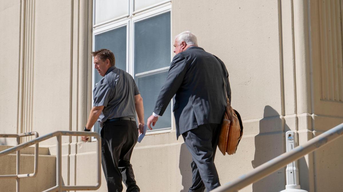 Agape Boarding School director Bryan Clemensen, left, and Agape’s attorney, John Schultz, leave the Cedar County Courthouse on Monday after a hearing on closing the school.