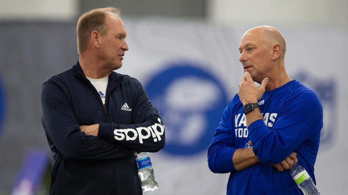 Kansas football coach Lance Leipold (left) talks with special assistant Sean Snyder (right) during the Jayhawks’ Pro Day on March 31, 2023.