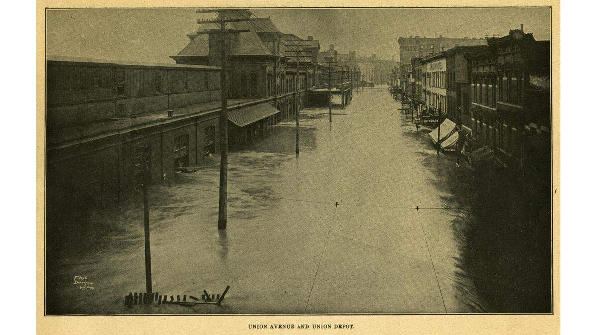 Union Avenue, its businesses, and the depot are overwhelmed by the 1903 Flood.