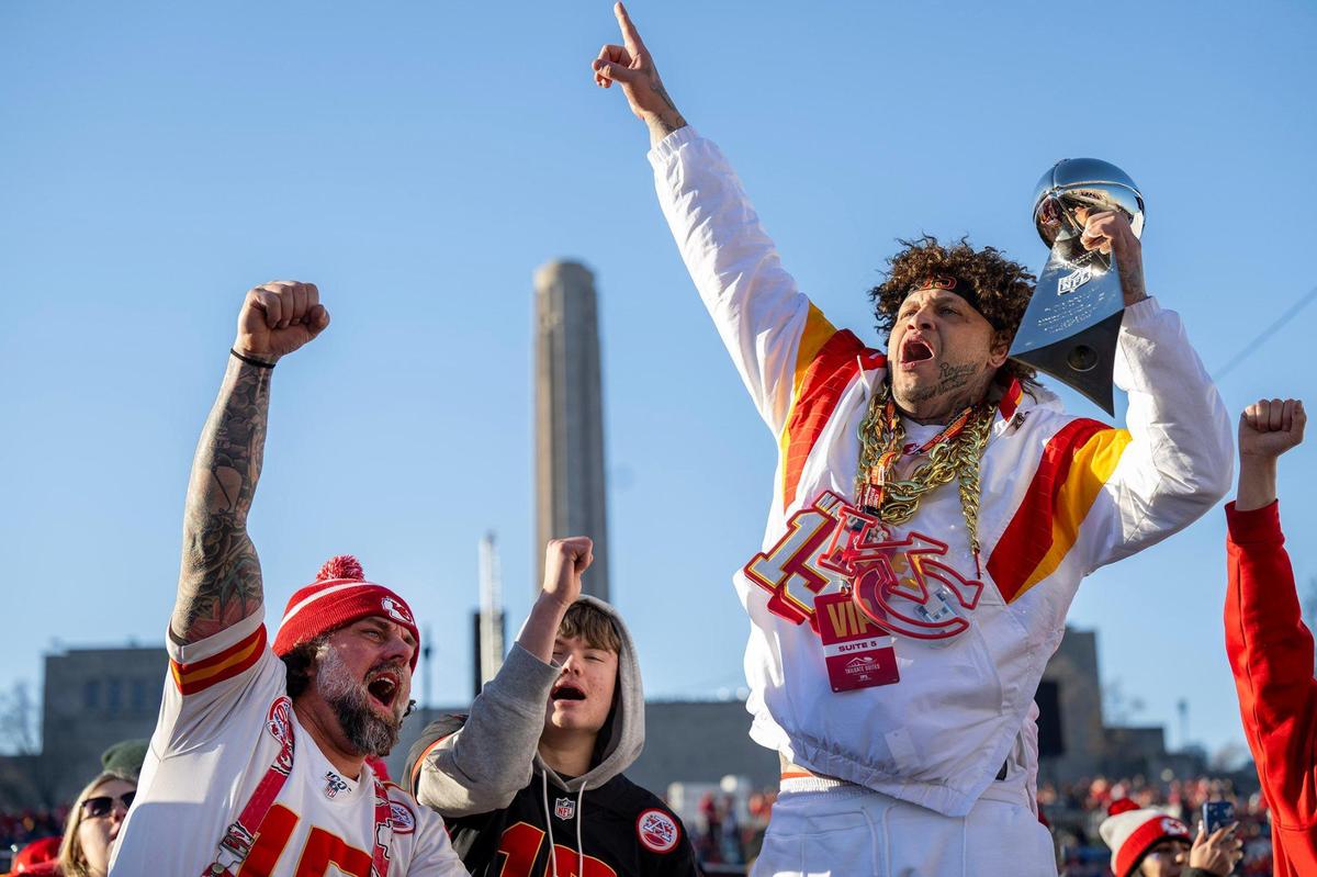 Chiefs fans Blair Falconer, left, of Overland Park, and Scott Shepard, right, of Kansas City, cheered on the Chiefs before the Super Bowl LVIII championship parade and rally on Wednesday, Feb. 14, 2024, in Kansas City. Falconer won the replica Lombardi trophy in a raffle.