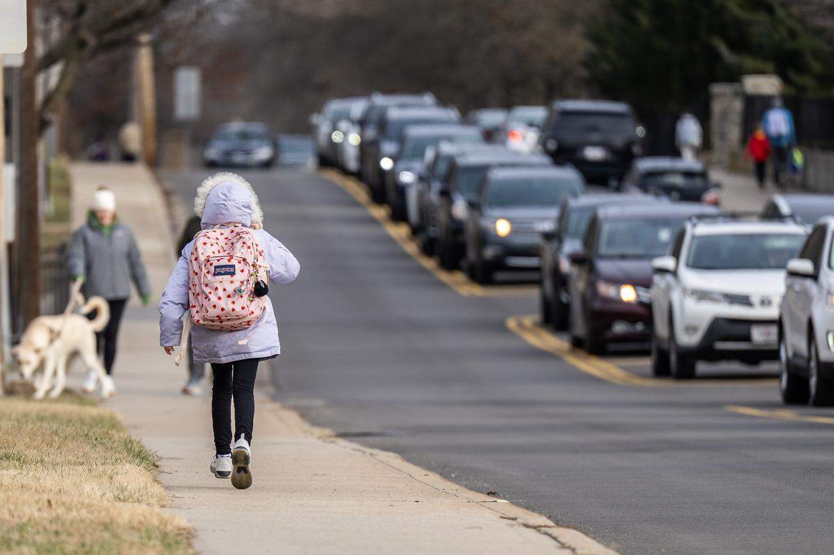 A child walks along West 83rd Street near Corinth Elementary School on Thursday, Jan. 15, 2026, in Leawood.