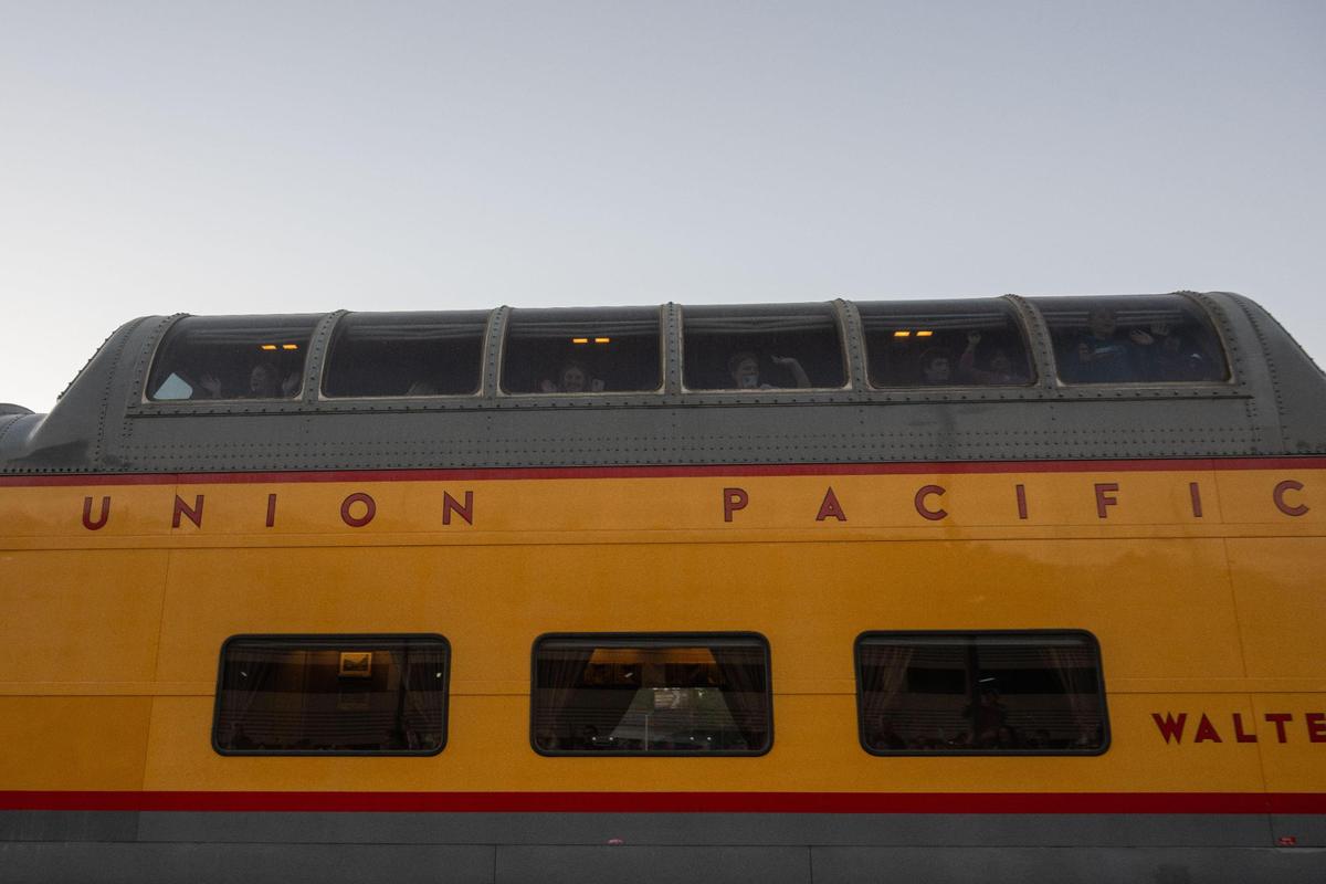 Passengers aboard the Union Pacific’s Big Boy wave at bystanders in Kansas City on Tuesday, Oct. 15, 2024.