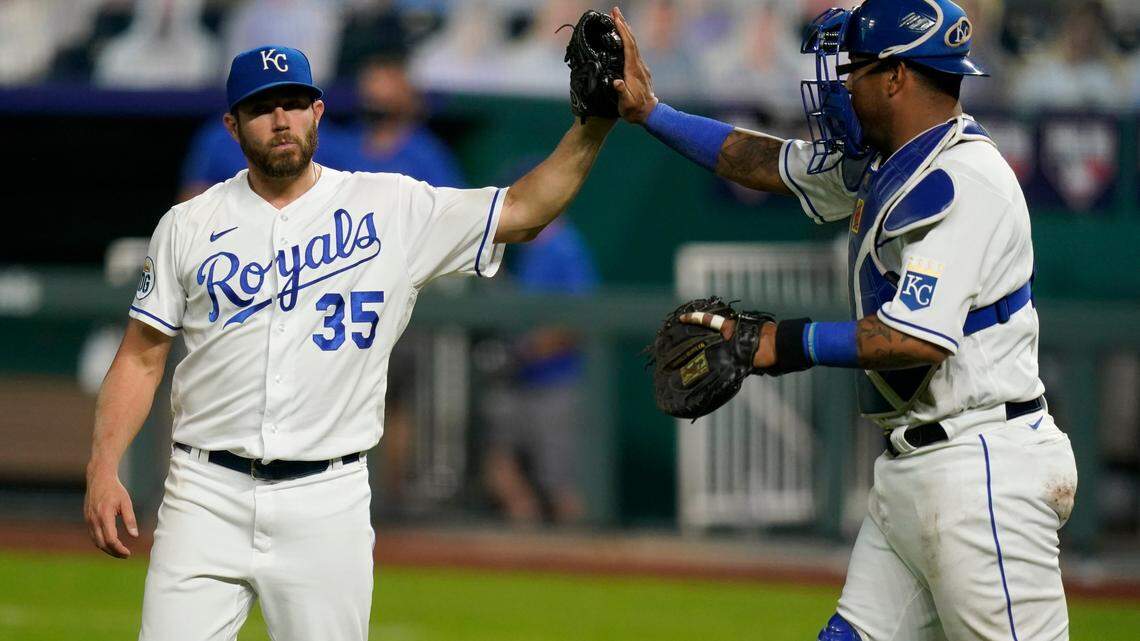 Kansas City Royals relief pitcher Greg Holland (35) and catcher Salvador Perez, right, celebrate following a baseball game against the St. Louis Cardinals at Kauffman Stadium in Kansas City, Mo., Monday, Sept. 21, 2020. (AP Photo/Orlin Wagner)