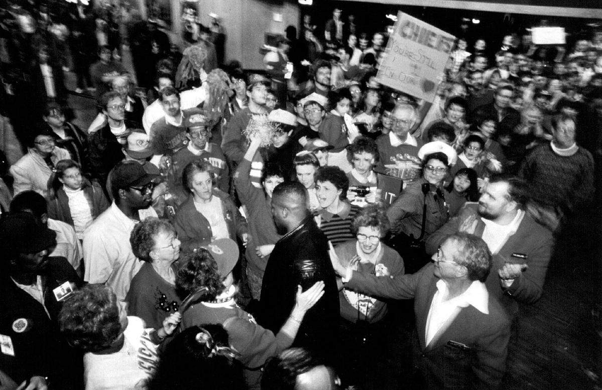A large crowd of devoted fans welcomed Kansas City Chiefs safety Deron Cherry (center) and the rest of the team as they returned to the Kansas City International Airport in this 1991 photo. The team lost their play-off contest to the Buffalo Bills 37-14 in Buffalo. Kansas City, Mo., police estimated about 600 fans came out to welcome the team home.