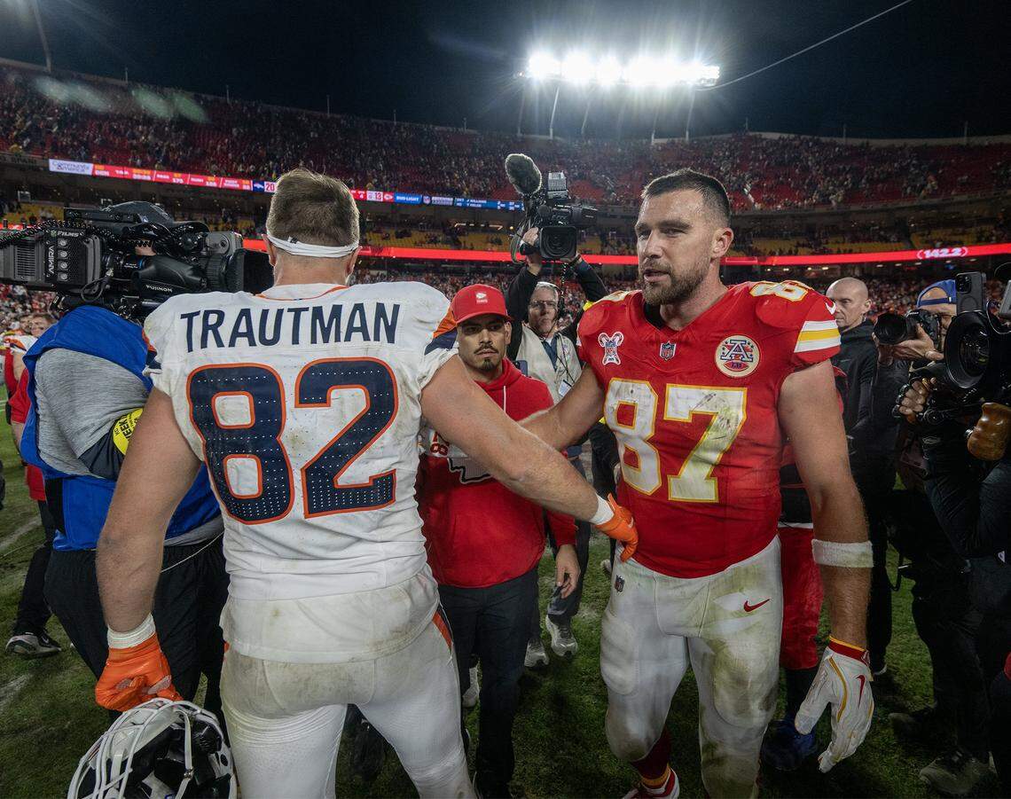 Kansas City Chiefs tight end Travis Kelce (87) greets Denver Broncos tight end Adam Trautman (82) as he heads off the field after the Denver Broncos defeated the Chiefs, 20-13, at GEHA Field at Arrowhead Stadium on Thursday, Dec. 25, 2025, in Kansas City.  