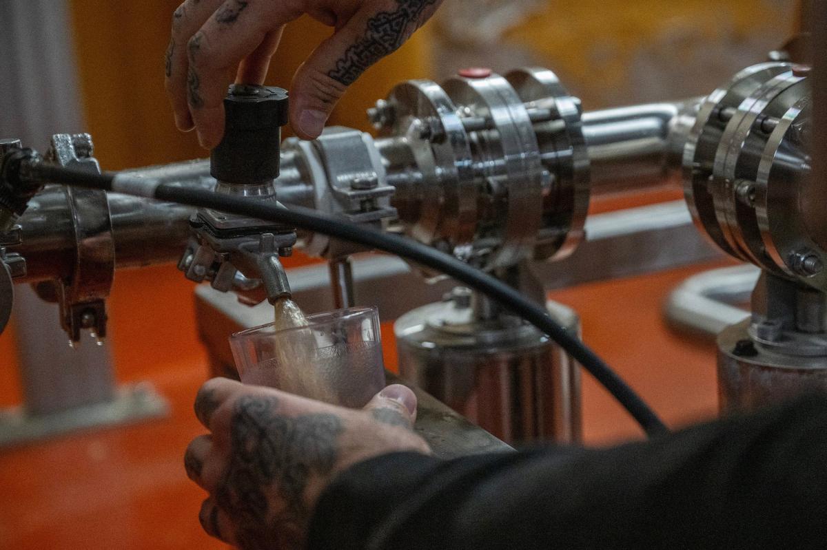 Greg Garrity, innovation brewer for Boulevard, takes a sample of experimental beer from a horizontal fermentation tank.
