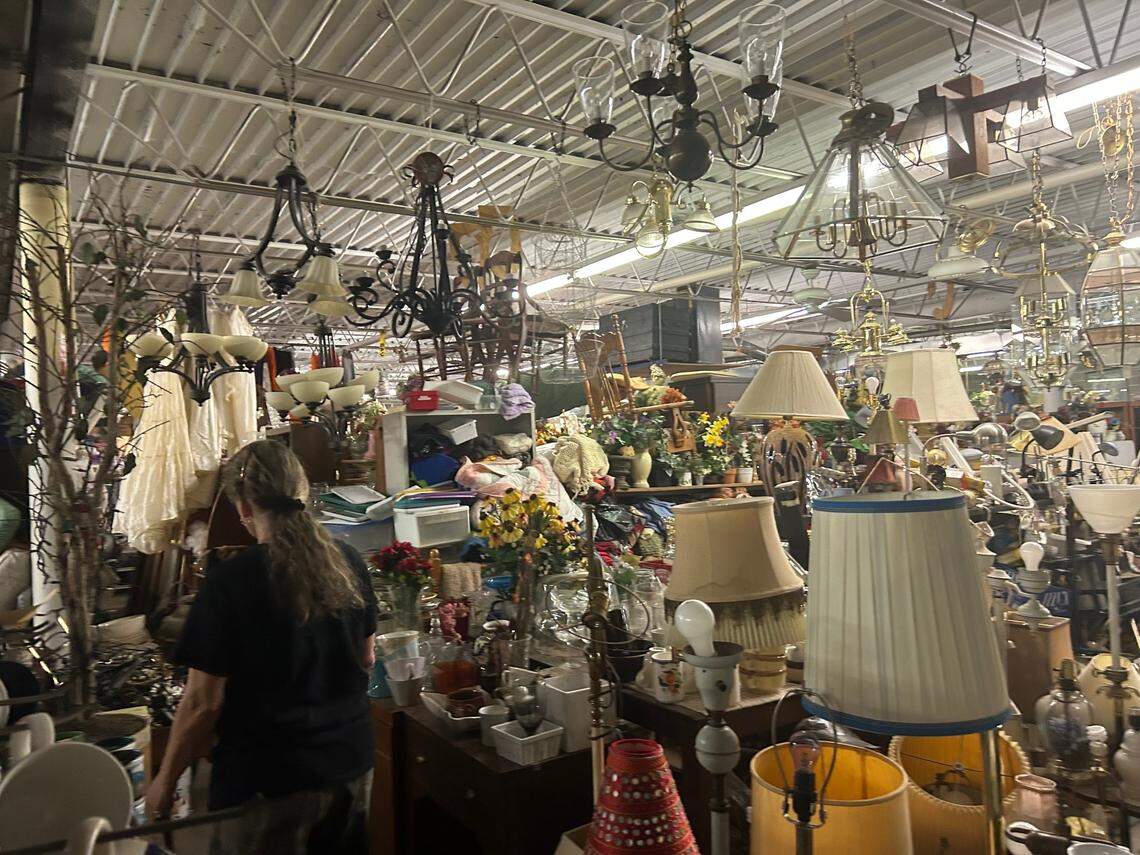 Lori Siegel wades through things at her Kansas City, Kansas, thrift shop.