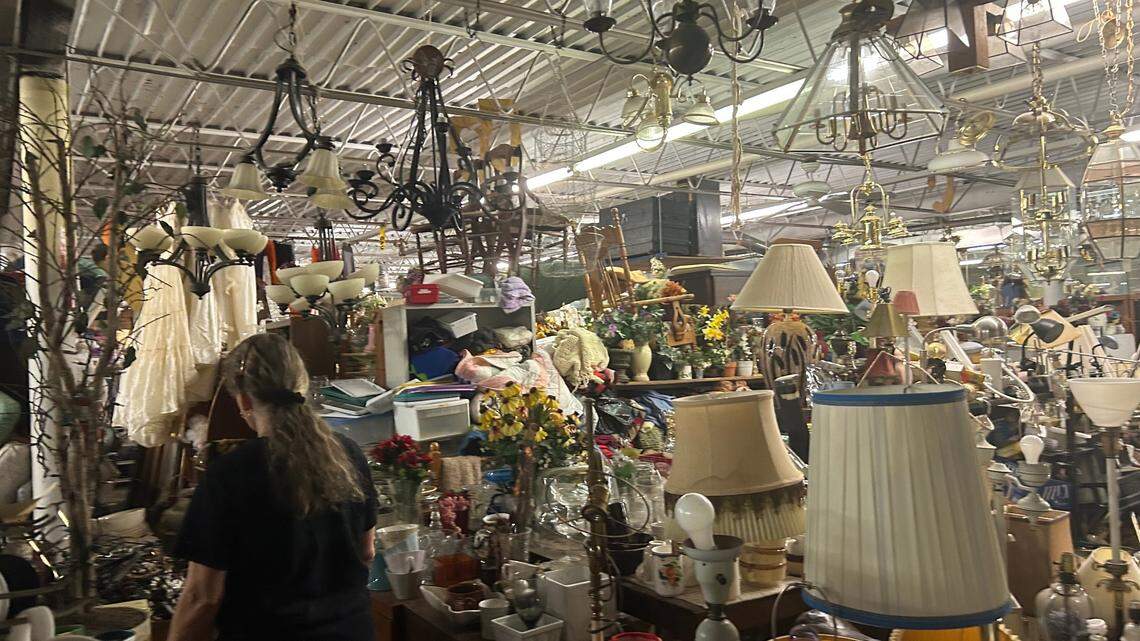 Lori Siegel wades through things at her Kansas City, Kansas, thrift shop.