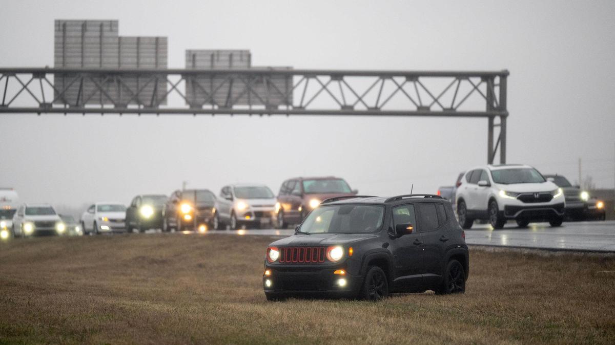 As freezing rain began to move into the area, an icy glaze slowed traffic to a crawl on southbound Interstate 35 near the U.S. 69 Highway exit Saturday, Jan. 4, 2024, in Lenexa. Some drivers opted to exit the highway and drive across the grass to the frontage road.