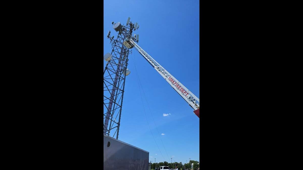 A man trapped under steel at the top of a cellphone tower was rescued on June 11, Nebraska fire officials said.