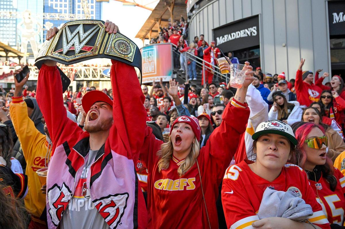 Chiefs fans Levi Marischler and Hannah Roberts of Lee’s Summit celebrate at KC Live! in the Kansas City Power & Light District while watching the AFC Championship game between Kansas City and Baltimore on Sunday, Jan. 26, 2024, in Kansas City.