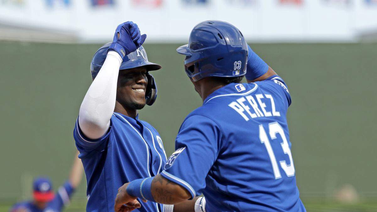 Kansas City Royals’ Jorge Soler, left, celebrates with Salvador Perez after hitting a two-run home run during the first inning of a spring training baseball game against the Texas Rangers Friday, Feb. 21, 2020, in Surprise, Ariz. (AP Photo/Charlie Riedel)