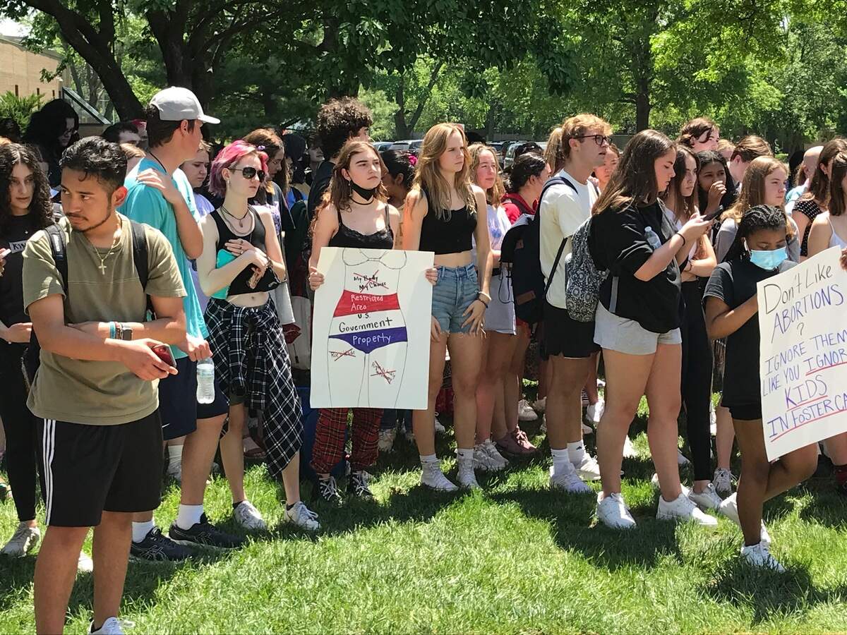 Blue Valley North High School students hold signs supporting reproductive rights during a walkout protest on Thursday, May 12.