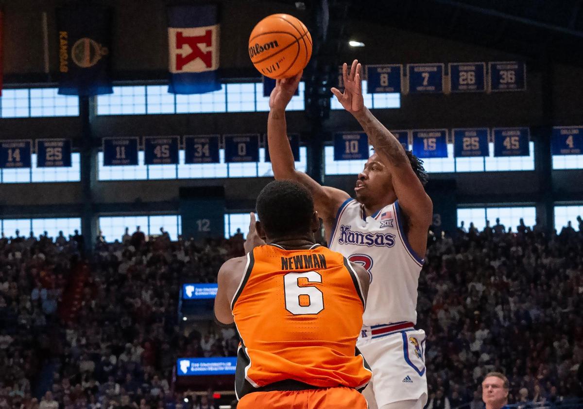 Kansas Jayhawks guard David Coit (8) gets a shot off as Oklahoma State Cowboys guard Brandon Newman (6) defends in the second half at Allen Fieldhouse on Saturday, Feb. 22, 2025, in Lawrence, Kansas.