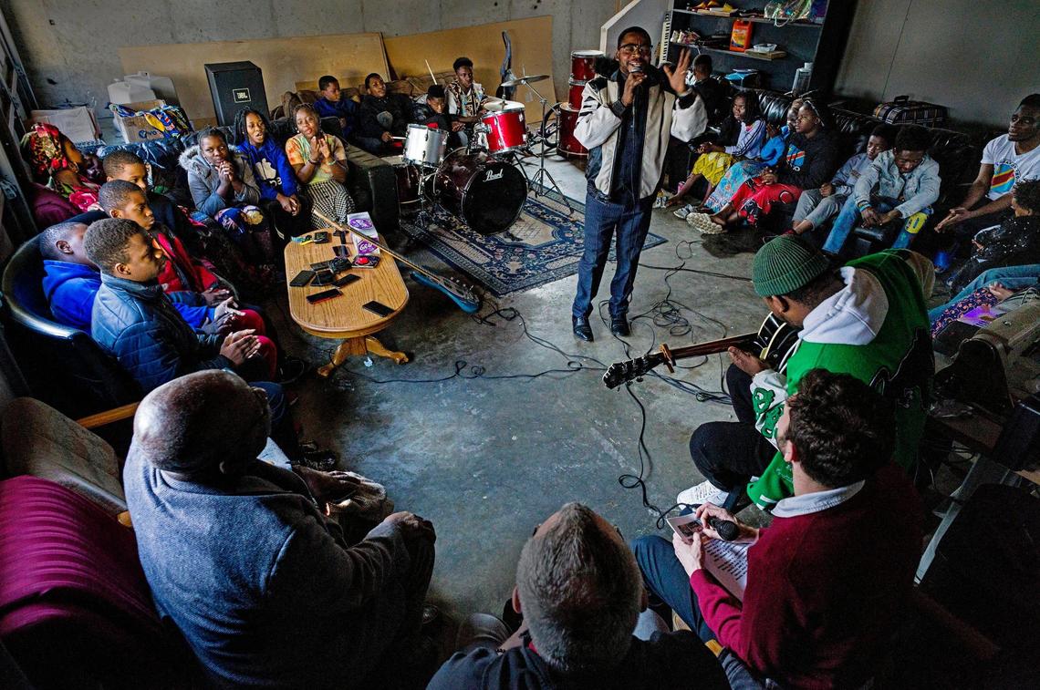 Inside a two-car garage in Kansas City’s Northeast area, Pastor John Wilondja leads the choir through a frenzied set of rumba, a style of African dance music with Cuban undertones. The Wilondja family moved here in 2018, and Pastor John eventually found work at Aspen Products, a local paper factory.