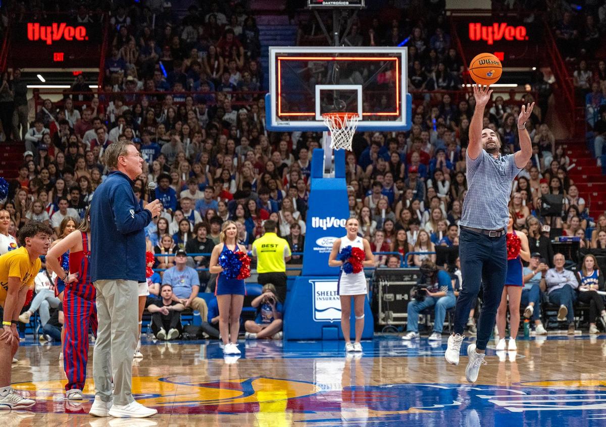 Kansas Head Coach Bill Self, left, looks on as Brennan Bechard, director of scouting for the Kansas Jayhawks, goes for a half-court shot and made it winning $5,000 for one student and $10,000 for another during the 40th annual Late Night in the Phog on Friday, October 18, 2024, at the newly renovated Allen Fieldhouse in Lawrence.
