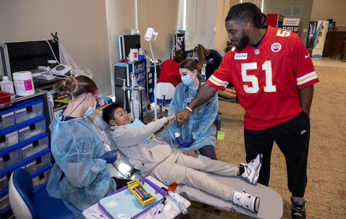 Kansas City Chiefs defensive end Mike Danna greeted Bryan Alamachi Guallichico, 10, of Kansas City, before Bryan had some free dental work done at the TeamSmile dental tailgate on Tuesday, Sept. 9, 2025 at GEHA Field at Arrowhead Stadium. More than 200 volunteer dentists, hygienists, and dental assistants provide the care backed by TeamSmile and the Chiefs.