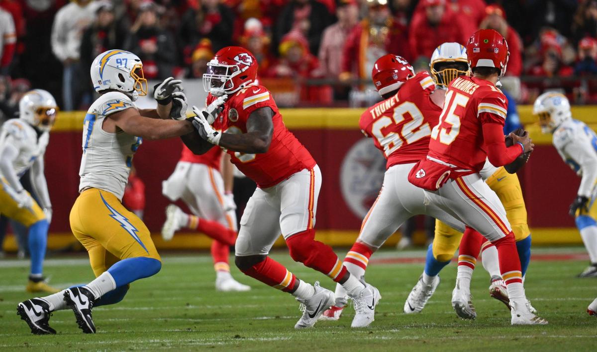 Kansas City Chiefs offensive tackle D.J. Humphries (70) blocks Los Angeles Chargers linebacker Joey Bosa (97) while quarterback Patrick Mahomes (15) looks for an open receiver in the first quarter on Sunday, Dec. 8, 2024, at GEHA Field at Arrowhead Stadium.