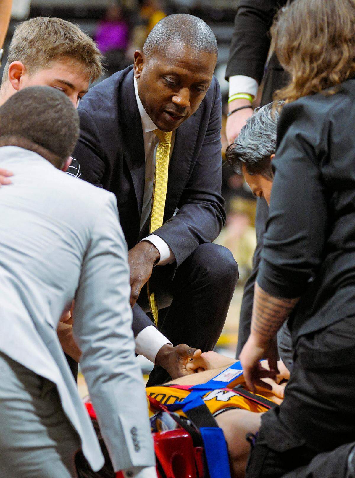Missouri Tigers head coach Dennis Gates talks with guard Caleb Grill (31) as he is being stretchered off the court after an injury during the first half against the Lindenwood Lions at Mizzou Arena on Nov. 27, 2024.