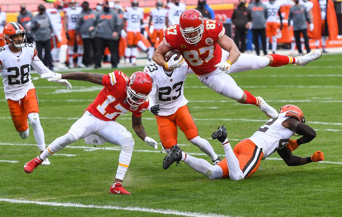 Kansas City Chiefs tight end Travis Kelce flies over Cleveland Browns strong safety Karl Joseph to score on a pass reception in the second quarter Sunday, January 17, 2021, at Arrowhead Stadium in Kansas City, Missouri.