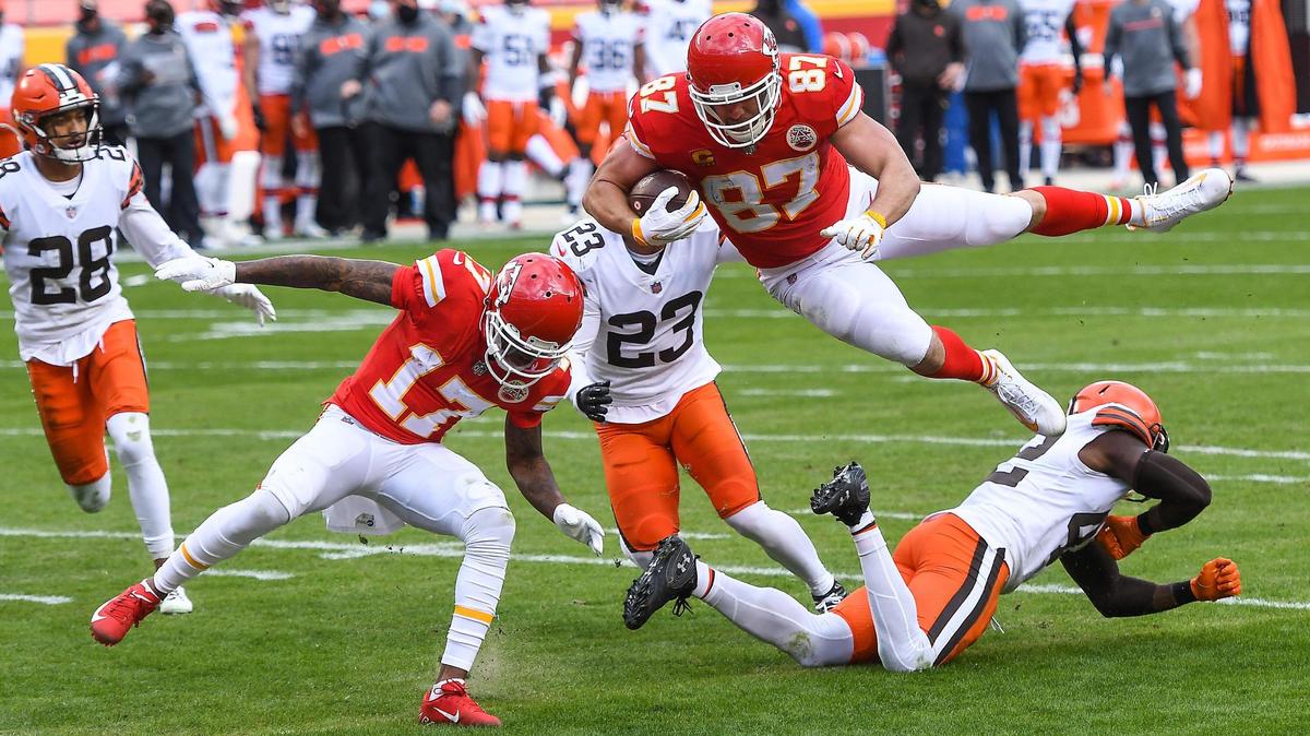 Kansas City Chiefs tight end Travis Kelce flies over Cleveland Browns strong safety Karl Joseph to score on a pass reception in the second quarter Sunday, January 17, 2021, at Arrowhead Stadium in Kansas City, Missouri.