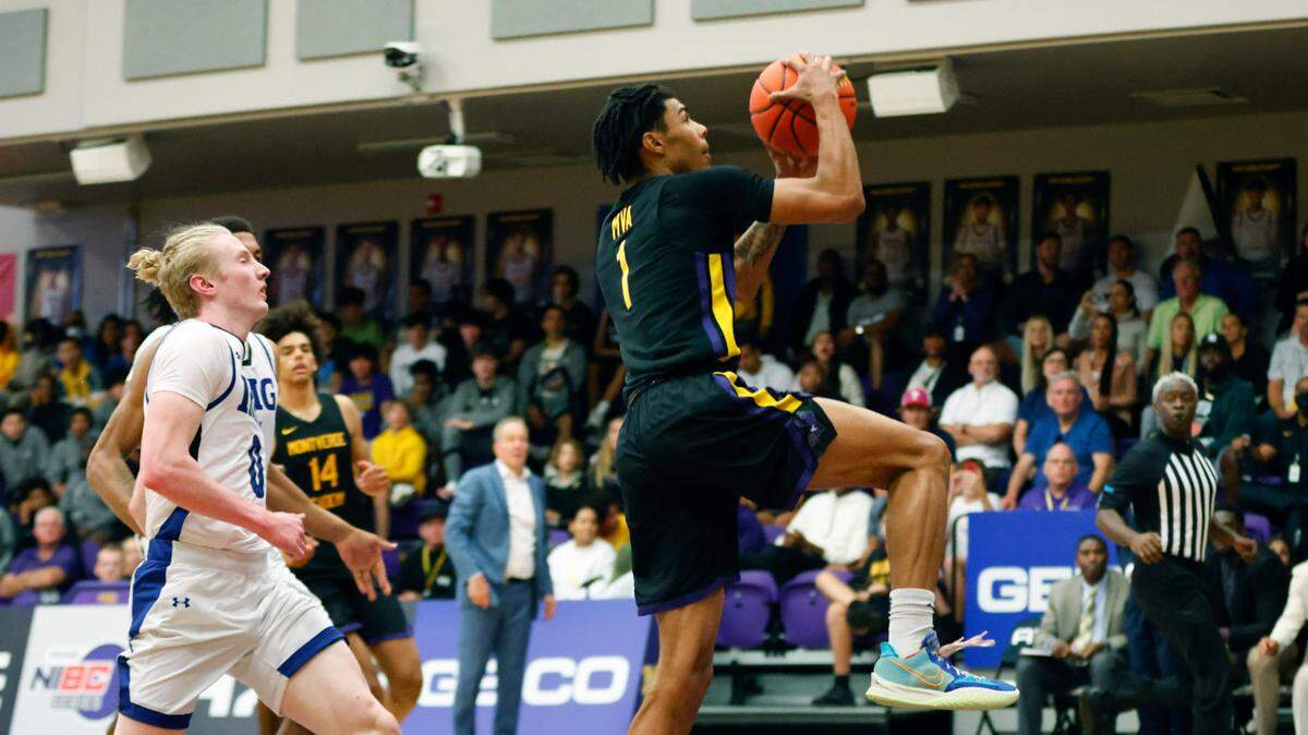 Montverde guard Chris Johnson (1) is chased by IMG Academy guard Blue Cain in the second quarter during the Sunshine Classic basketball tournament at Mills Championship Court on Dec. 1, 2022.