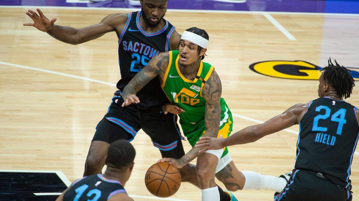 Sacramento forward Chimezie Metu (25) and guard Buddy Hield (24) guard Utah Jazz guard Jordan Clarkson (00) during the second half of a May 16, 2021 game.